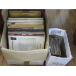 A collection of vinyl records, including singles by Blondie, Tom Jones (Delilah), Abba (Waterloo)