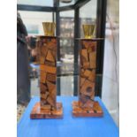 A pair of Hayadith Jerusalem-ware inlaid olive wood candle holders with brass sconces, both with