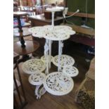 A Victorian painted cast iron three tier plant stand, in the style of Coalbrookdale, each tier