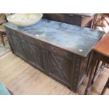 An 18th century oak coffer, the hinged lid over a lunette carved frieze and lattice carved panels,