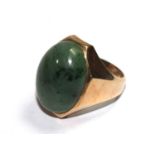 A gentleman's 14 carat gold ring set with possibly a jade stone