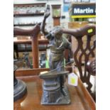 After E. Saalmann, a bronze of a blacksmith at his anvil, signed on the base, 32 cm high