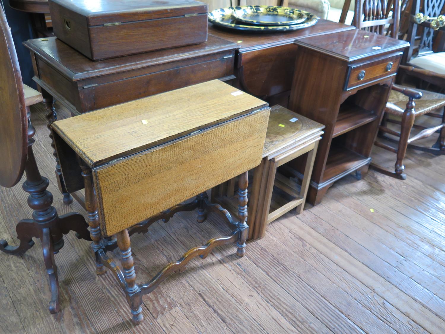 A nest of Indian teak tables, a small turned oak gateleg table and a reproduction open bookcase with