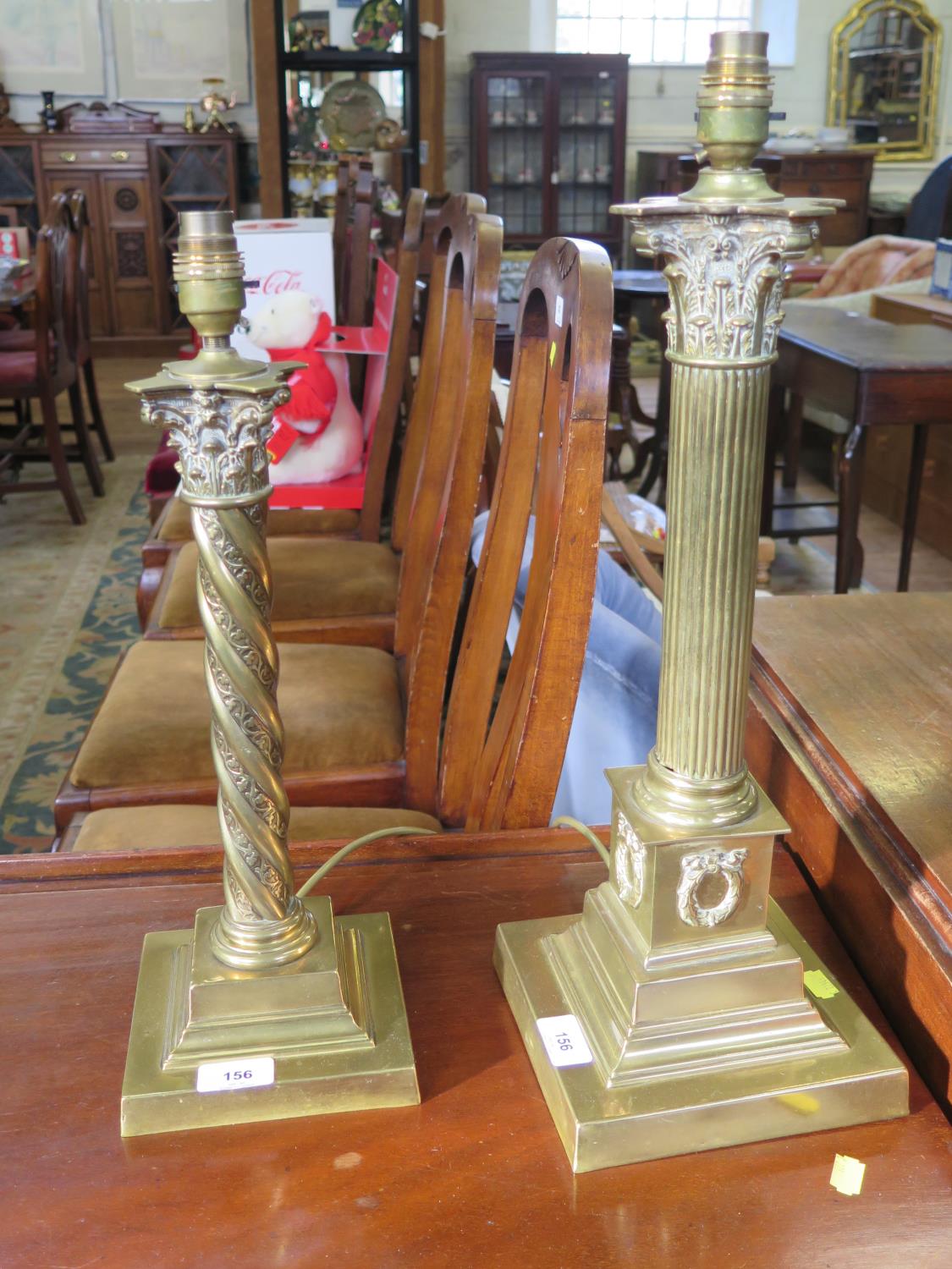 A brass table lamp, of Corinthian column form, with wreaths to the stepped base, 44 cm high, and