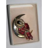 A Butler & Wilson enamelled brooch, in the form of a Pierrot sitting in crescent moon, in box