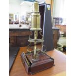 A Culpeper type lacquered brass microscope, unsigned, with circular platform and S-shape supports,