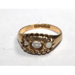 A ladies gem set ring in 18 carat gold (two stones missing)