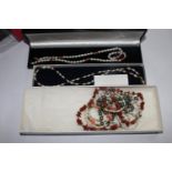 A bag with six pearl, coral and garnet decorated necklaces in boxes