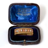 A SCARF CLASP WITH PEARL AND CORAL DECORATION in fitted box from W.L. Lawson, Lord St, Liverpool