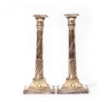 A PAIR OF 19TH CENTURY SILVER PLATED CANDLESTICKS of classical column form, the column shafts