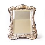 A SILVER MOUNTED DRESSING TABLE MIRROR the frame embossed with daffodils, marks for London and