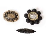 THREE VICTORIAN MOURNING BROOCHES in gilt metal and jet, including box