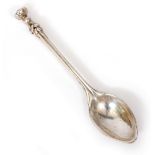 AN ARTS AND CRAFTS OMAR RAMSDEN SILVER SPOON with a stylized finial and a hammered bowl, with