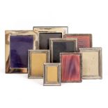 A COLLECTION OF SILVER PLATED AND WHITE METAL PHOTOFRAMES the largest 23cm overall (8)