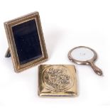 A SMALL SILVER PHOTOFRAME, a silver backed hand held mirror and an arts and crafts silver card