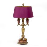 AN EMPIRE STYLE CAST BRASS THREE BRANCH TABLE LAMP with purple shade, 50cm high