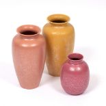 A MOTTLED YELLOW GROUND POOLE POTTERY VASE together with a mottled coral Poole Pottery vase and a