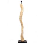 A FLOOR STANDING LAMP constructed from a sculptural wooden branch, on a square black painted base,