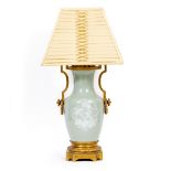 A CELADON GLAZED TABLE LAMP with gilt metal mounts, 24cm wide overall x 52cm high to the top of