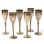 A SET OF SIX LATE 20TH CENTURY HAMMERED SILVER GILT CHAMPAGNE FLUTES by Stuart Devlin, each 20.5cm