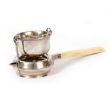 AN EARLY 20TH CENTURY SILVER TEA STRAINER with an ivory handle by Fredericks Limited and retailed by