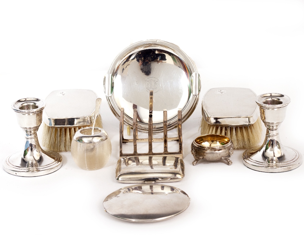 A PAIR OF SILVER CANDLESTICKS together with a silver mounted ashtray, a toast rack, white metal