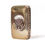 A CONTINENTAL WHITE METAL SNUFF BOX the lid set with a medallion, with gilt interior, 8cm wide