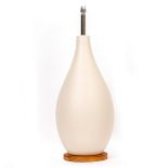 AN EGGSHELL GLAZED OVOID TABLE LAMP on a circular pine base, 27cm wide x 76cm high