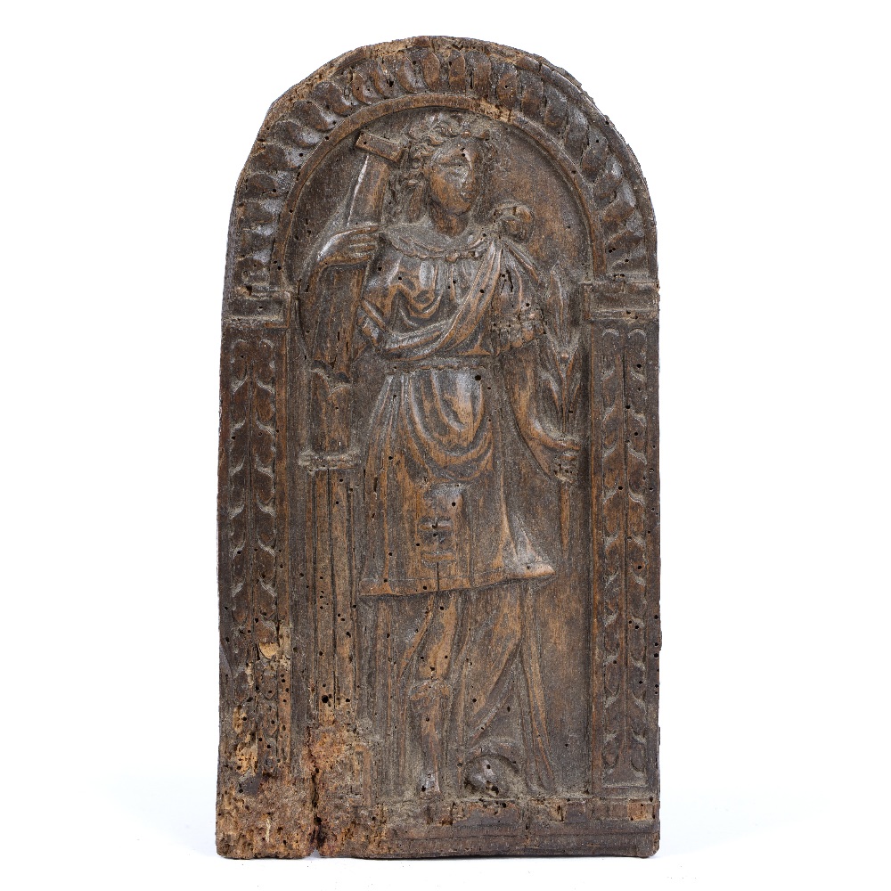 A 17TH OR 18TH CENTURY CARVED WALNUT PANEL depicting a woman in classical dress holding a column and