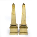 A PAIR OF BRASS OBELISKS set on plinth bases 15.3cm wide x 58.5cm high