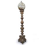 A LARGE BRASS FLOOR LAMP in the form of an oversized alter candlestick on tripod base, surmounted by