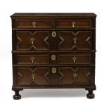 A 17TH CENTURY OAK CHEST OF TWO SHORT AND THREE LONG DRAWERS with geometric mouldings and raised