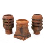 A PAIR OF TERRACOTTA CHIMNEY POTS each 50cm high and a further terracotta chimney pot (3)