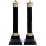 A PAIR OF EMPIRE STYLE BLACK PAINTED TABLE LAMPS in the form of cylindrical columns on square bases,