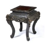 A CHINESE CARVED EBONISED WOOD URN STAND of square section, standing on shaped legs and