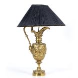 A TABLE LAMP constructed from a gilt cast metal ewer of classical form decorated with putti and