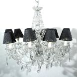 A NINE LIGHT GLASS AND WHITE METAL ELECTROLIER OR CHANDELIER with scrolling arms and moulded glass
