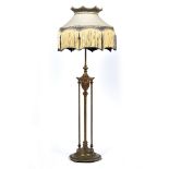 AN EARLY 20TH CENTURY GILT METAL ADJUSTABLE LAMP STANDARD later converted for electricity with