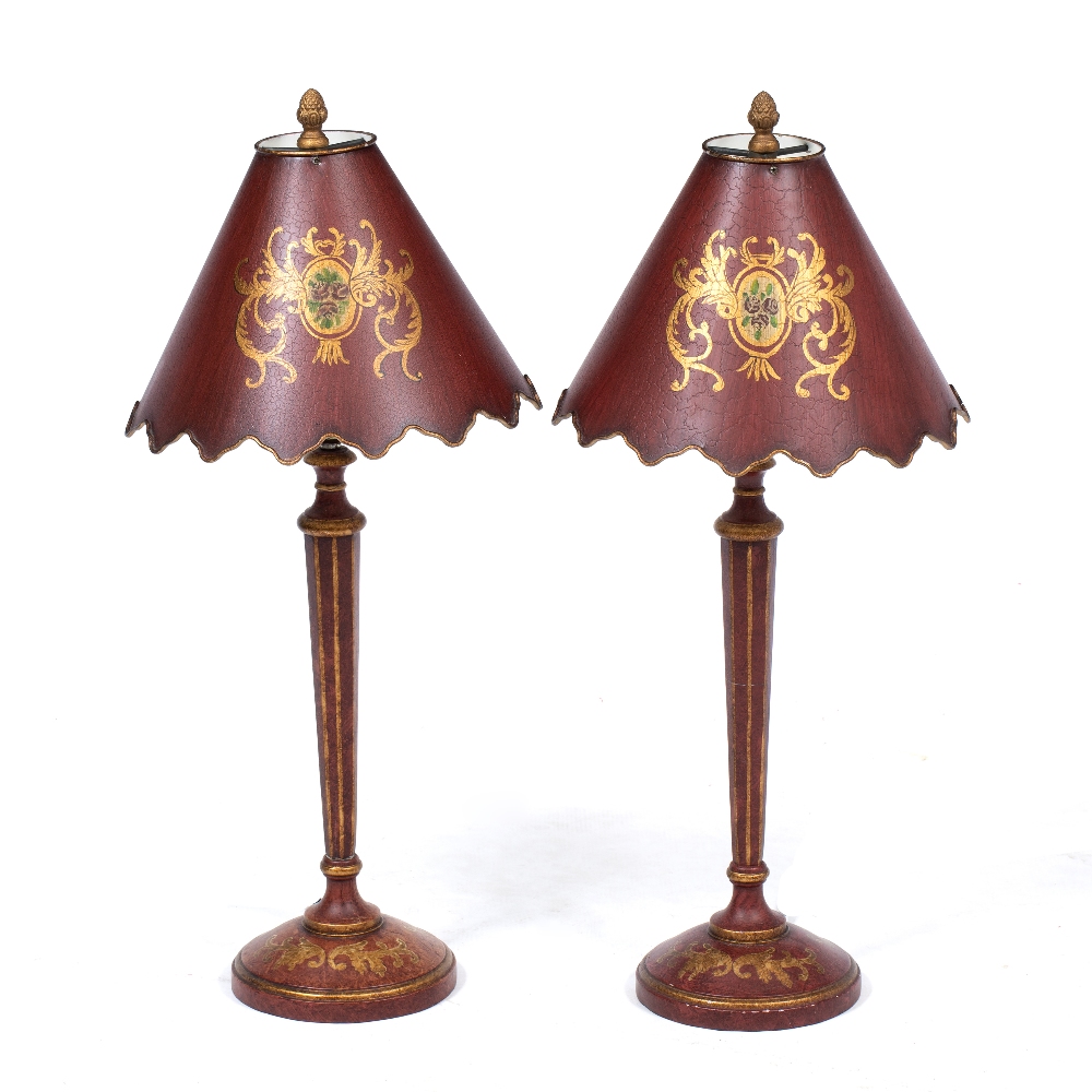 A PAIR OF RED LACQUERED PARCEL GILT TABLE LAMPS with fluted tapering column and circular spreading