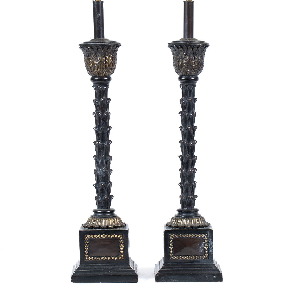 A PAIR OF BLACK PAINTED AND PARCEL GILT TABLE LAMPS the central supports in the form of palm tree