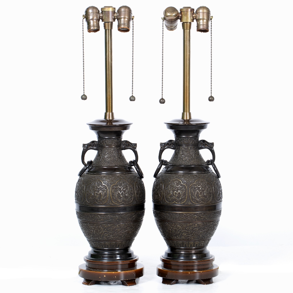 A PAIR OF TABLE LAMPS in the form of cast bronze Oriental style vases, decorated with bands of
