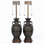 A PAIR OF TABLE LAMPS in the form of cast bronze Oriental style vases, decorated with bands of