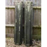 A PAIR OF CARVED STONE COLUMNS with Gothic tracery style decoration to three of the six sides, 24.