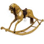 A CONTEMPORARY CARVED WOODEN ROCKING HORSE by N Bovey of Newton Abbott Devon, with leather saddle,