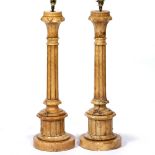 A PAIR OF CARVED STONE TABLE LAMPS in the form of fluted columns, each on a circular base, 19cm