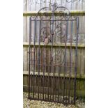 A WROUGHT IRON GARDEN GATE with scrolling designs 107.5cm wide including mounting bracket, 192cm