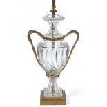 A GLASS AND GILT METAL MOUNTED TABLE LAMP in the form of a lidded urn with scrolling handles and