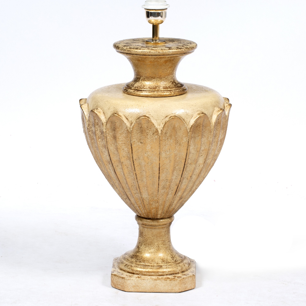 AN ITALIAN GILDED TABLE LAMP of baluster form, 60cm high together with two similar candlesticks,