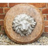 A VICTORIAN STONEWARE CIRCULAR PLAQUE decorated with a lion mask, 47cm diameter