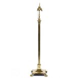 A BRASS LAMP STANDARD of classical column form on a square stepped base terminated in claw and